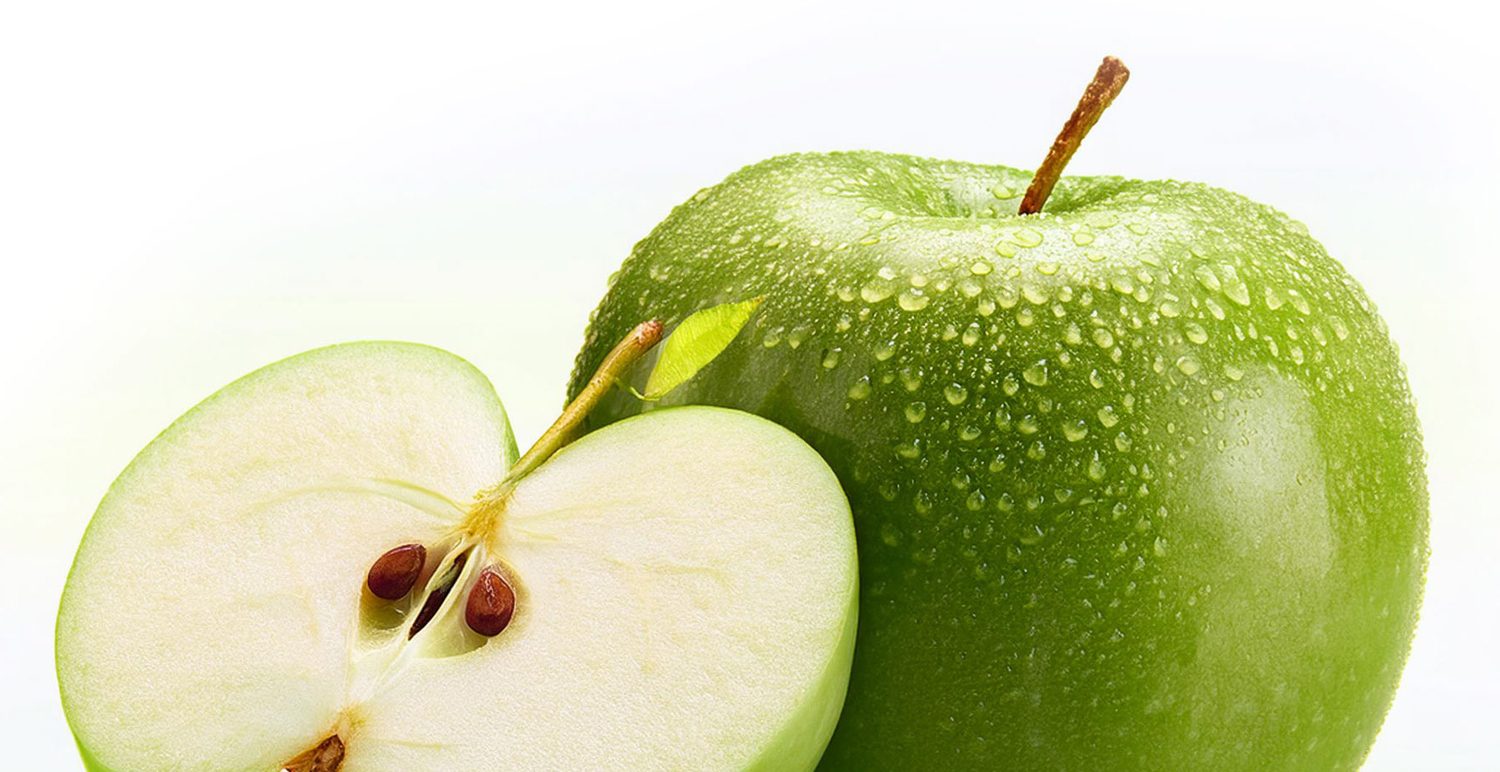 Fresh green apple, whole and halved